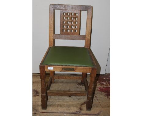 A Robert 'Mouseman' Thompson oak adzed chair with lattice work back panel and trademark carved mouse to one leg. Has a brass 