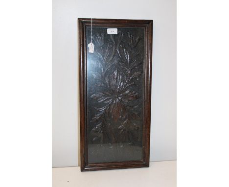 A framed &amp; glazed carved oak panel 60cm x 29cm 