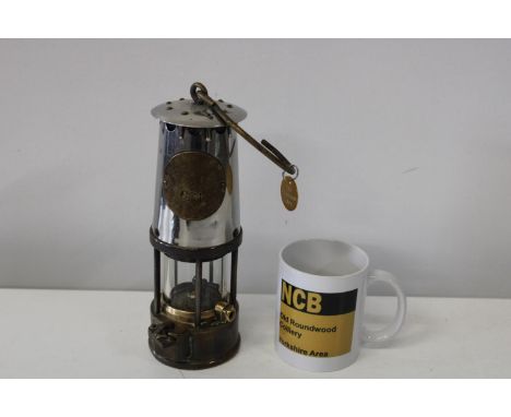 A vintage colliery miners lamp, pit check and NCB mug 