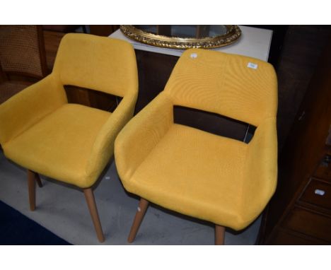 A pair of mustard yellow modern waiting chairs, in a vintage style