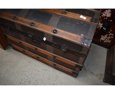 A vintage dome top travel trunk