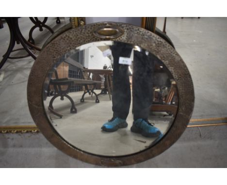 A vintage brass framed circular wall mirror