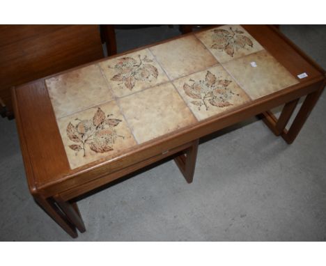 A vintage teak and tile top coffee table with nesting pair under