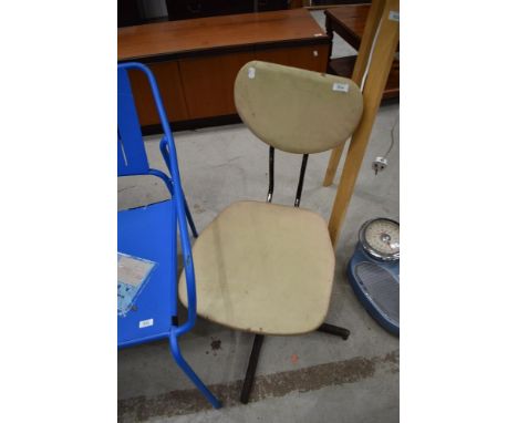A vintage vinyl office chair on metal swivel frame