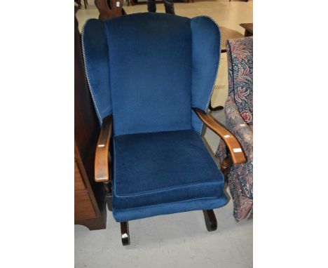A vintage stained frame rocker having blue dralon upholstery
