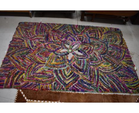 A vintage multi colour pegged rug