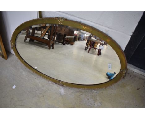A vintage brass framed wall mirror