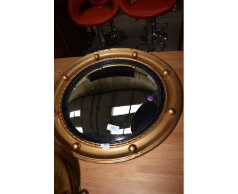 A vintage convex wall mirror