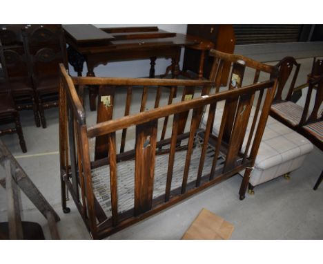 A vintage wooden child's cot, sold as decorative