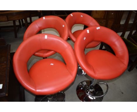 A set of four vintage style red vinyl and chrome bar stools