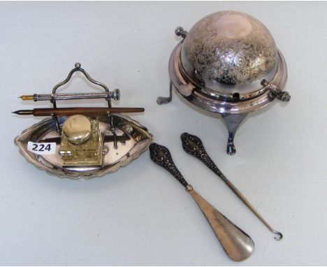 A sterling silver pen & pencil on a plated stand, a silver handled button hook and shoe horn & a muffin dish.