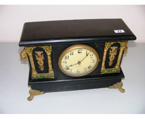 A Gilbert mantle clock, the wooden case standing on four gilt scroll feet.