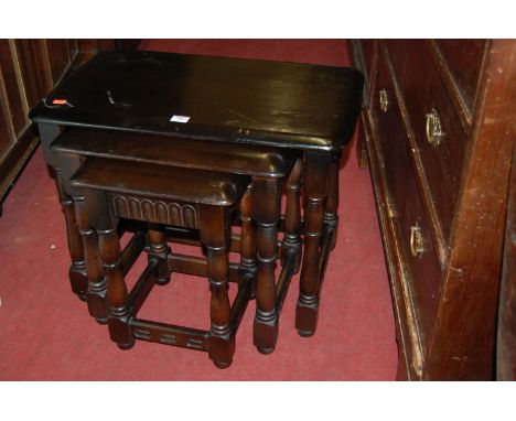 An Ercol dark elm nest of three occasional tables 
