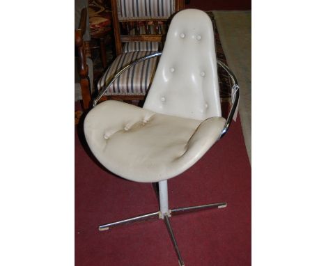 A pair of 1960s chrome framed and cream vinyl button back upholstered swivel open elbow chairs