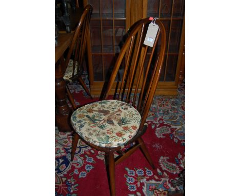 A pair of Ercol dark elm stickback dining chairs