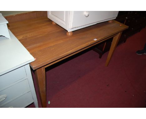 A contemporary light oak rectangular dining table