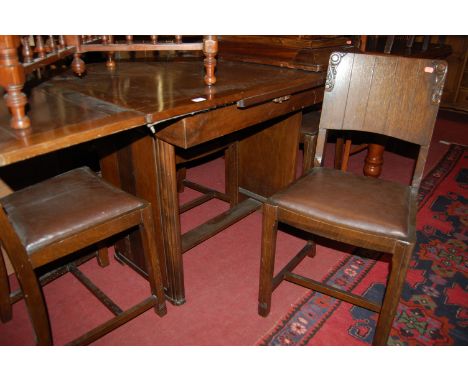 A 1930s Ercol moulded oak draw leaf dining table, together with a set of four oak panel back dining chairs (5)