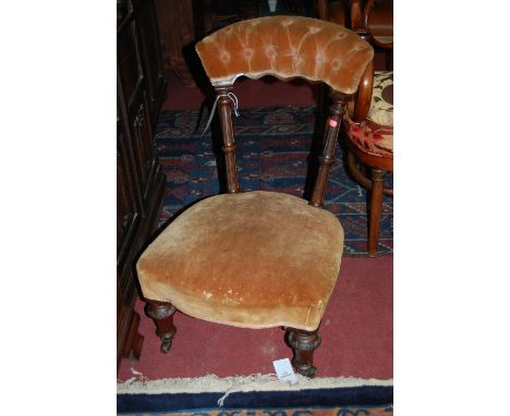 A Victorian walnut framed and button back upholstered nursing chair