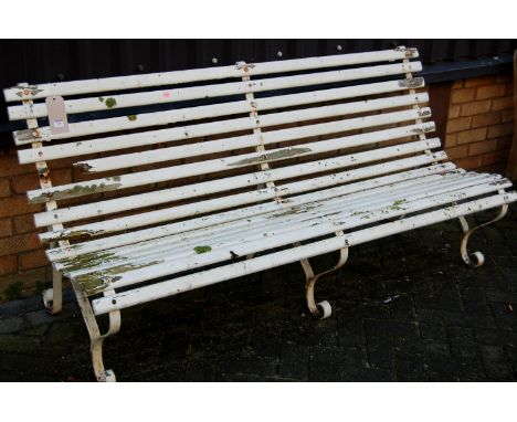 A 19th century painted wrought iron and slatted three seater garden bench 