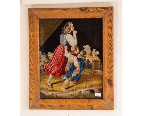 A woodwork needlepoint of woman and boy rushing towards a gate.&nbsp;