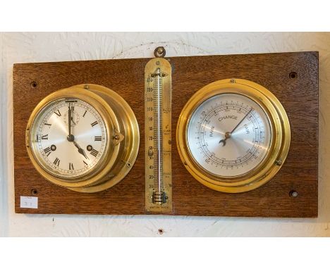 A wall mounted brass clock, barometer and thermometer display.&nbsp;