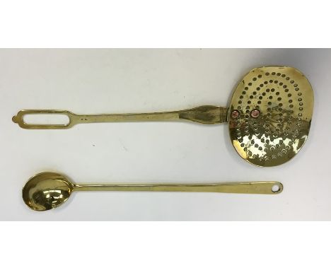 An 18th century brass dairy skimmer, two copper rivers secure the handle to the pan, L.43 cms (17”) and a brass deep bowl spo