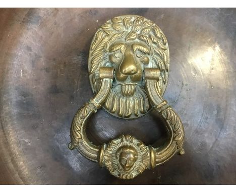 A cast lions head door knocker.&nbsp;