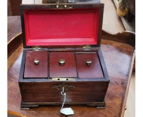 A George III mahogany tea caddy, the stepped hinged top opening to reveal three compartments, brass swing handle, brass escut