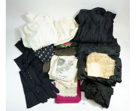 A box of antique and vintage textiles including Victorian black silk skirt and blouse, white full length apron, black silk ap