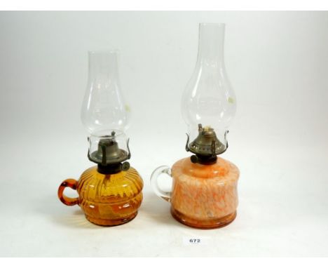 A Victorian mottled orange glass finger lamp and an orange clear glass one 
