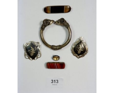 A silver rams head hinged bangle, two agate brooches, two silver Siam brooches and a citrine brooch 