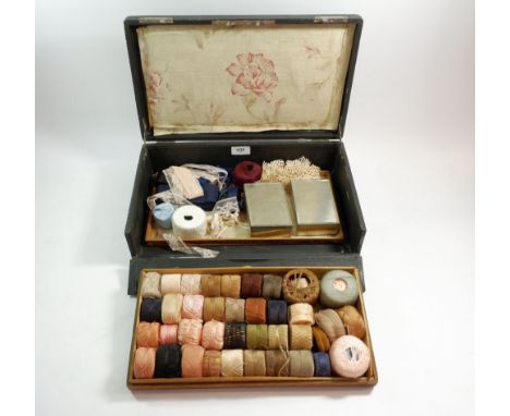 A French leather covered sewing box with compartments containing silks and sewing materials, impressed with the initials C J 