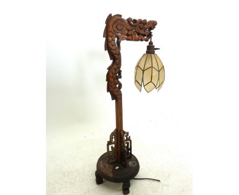 A Chinese dragon form carved table lamp with pendant hanging shade 72cm tall 