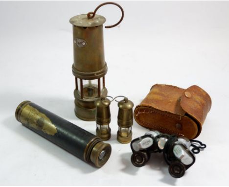 A box of collectables including miners lamp, a pair of miniature turned bras miners lamps, a pair of cased binoculars and a t