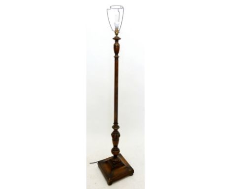 A turned wood standard lamp on square base 