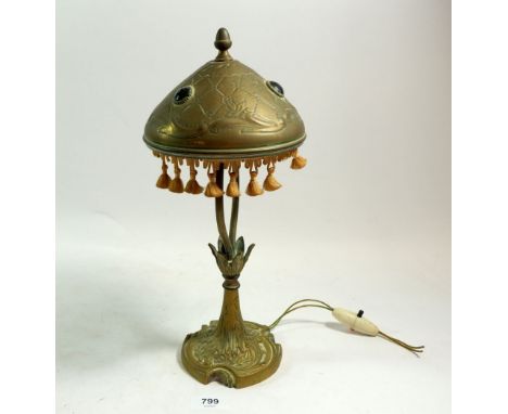 An Arts &amp; Crafts cast brass table lamp, the embossed brass shade with inset 'stones', 34cm tall 