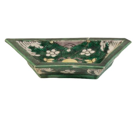 A FAMILLE VERTE FAN-SHAPED SWEETMEAT DISH Kangxi, with flowers and precious objects on a green wave ground, 14.5cm wide Prove