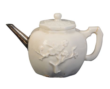 A DEHUA BLANC DE CHINE TEAPOT AND COVER Kangxi, late 17th century, of octagonal form, each side moulded in relief with a flow