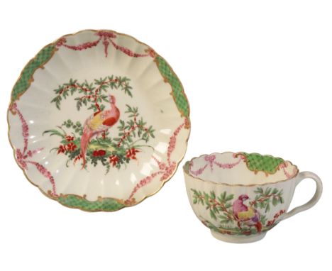 A WORCESTER FLUTED FANCY TEACUP AND SAUCER circa 1778-82, painted in columns, each with an exotic bird before a tree in the D