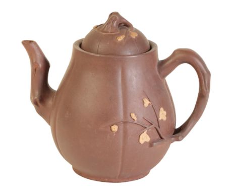A DARK YIXING TEAPOT probably Kangxi, moulded in naturalistic form, with flowering prunus highlighted in gilt, 14cm high 