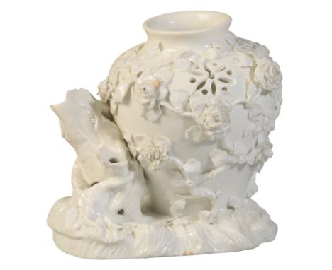 A VINCENNES WHITE POT POURRI VASE circa 1748-50, the vase leaning against a tree trunk with applied flowers, 17.5cm high