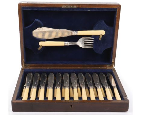 An early 20th century silver plate and bone handle fish knife and fork set for twelve with a fish serving set in lid, in oak 