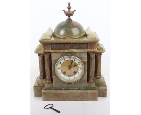 A French 19th century green onyx mantle clock, white dial with Roman numerals, brass urn finial, and four brass pillars, 38cm