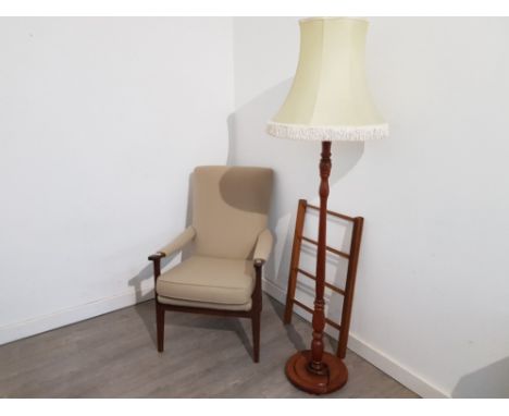 A stained beech open armchair, standard lamp with cream shade, and a towel airer.
