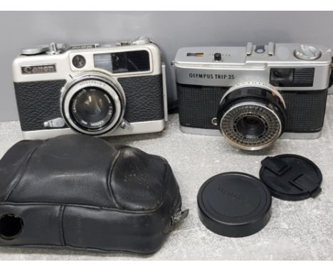 Vintage Olympus Trip 35 camera together with a Canon demi EE17 camera with original case