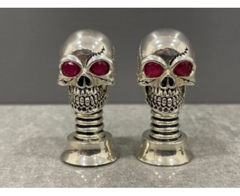 A pair of silver plated Skull condiments set with Ruby eyes 61.2g gross
