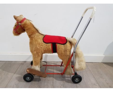 A vintage Tri-ang child's horse push toy.
