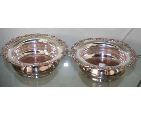 A large pair of electroplated wine coasters, with grape vine borders