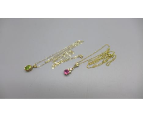A 9ct gold and peridot pendant and chain, 0.8g and a ruby and diamond pendant and chain, 1.4g 