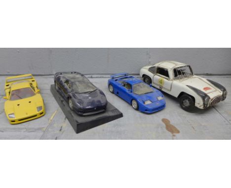 Three Burago 1/18th scale model vehicles and a tin plate sports car 